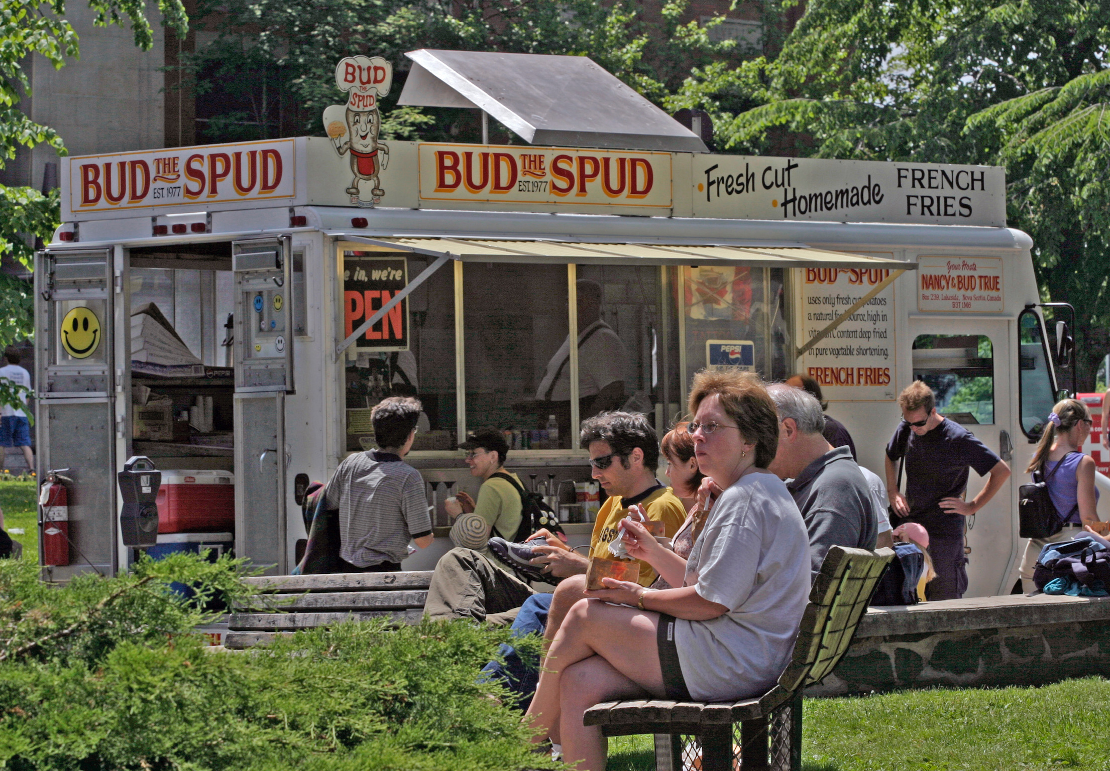 BUDtheSPUD customers at outdoor tables, hand-cut fries being served